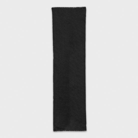 Discover the elegance of the black cashmere scarf, exclusively at Wools Boutique Uomo in Geneva, handcrafted in Italy, this mono color scarf adds sophistication to any outfit.